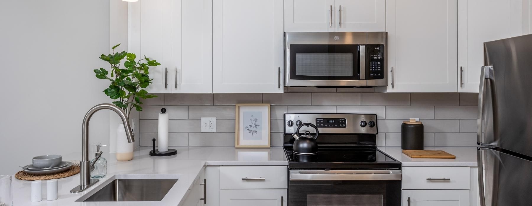 a kitchen with white cabinets