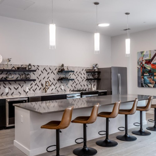 a kitchen with stools and a bar